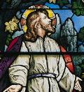 Stained glass window of Jesus praying